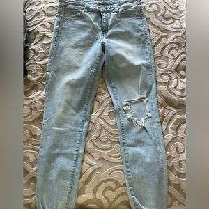 Size 12 Light Washed American Eagle Jeans with rip on the knee